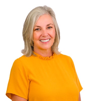 Portrait of Kristina Cusick, REALTOR®, CRS, Broker/Owner.